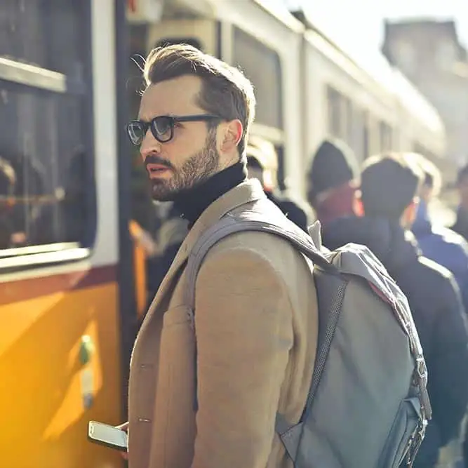 Man boarding bus at transit stop